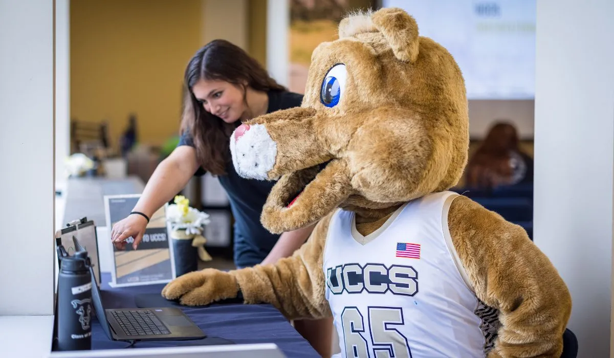 Clyde working with a UCCS admissions counselor